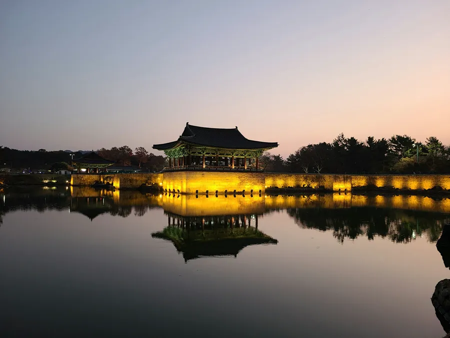 The Donggung Palace pavilion at Wolji Pond, lit up and reflected in the water at dusk