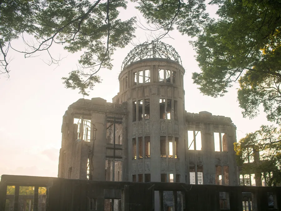The Atomic Bomb Dome in Hiroshima Peace Memorial Park, backlit by late-day sun