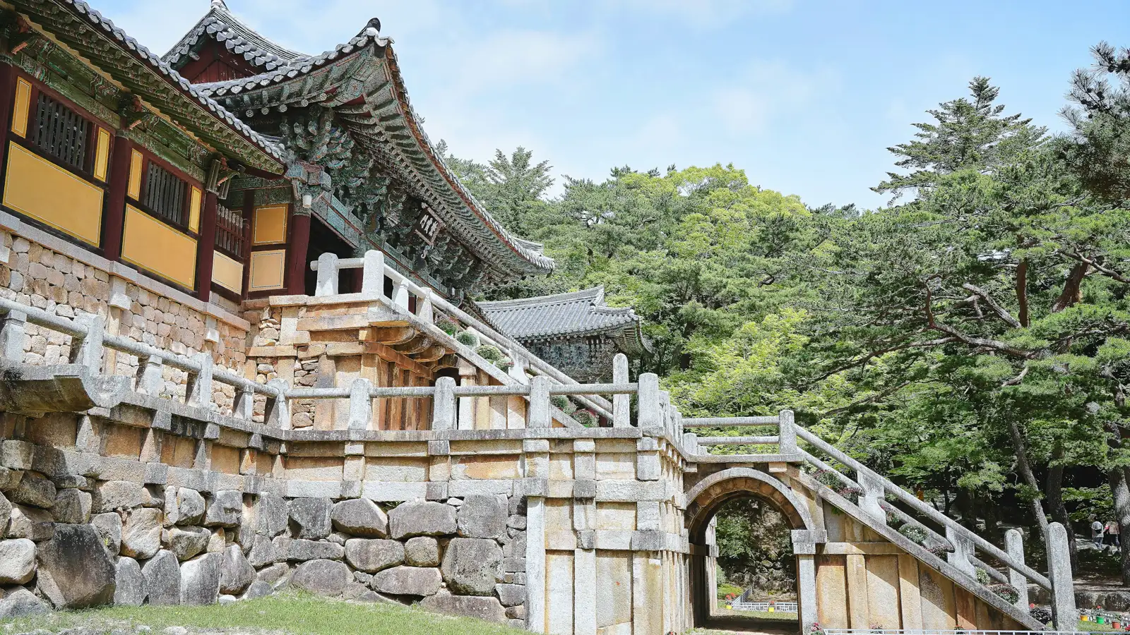 Stone bridge staircases and the tiled pavilion of Bulguksa Temple in Gyeongju, pine trees behind