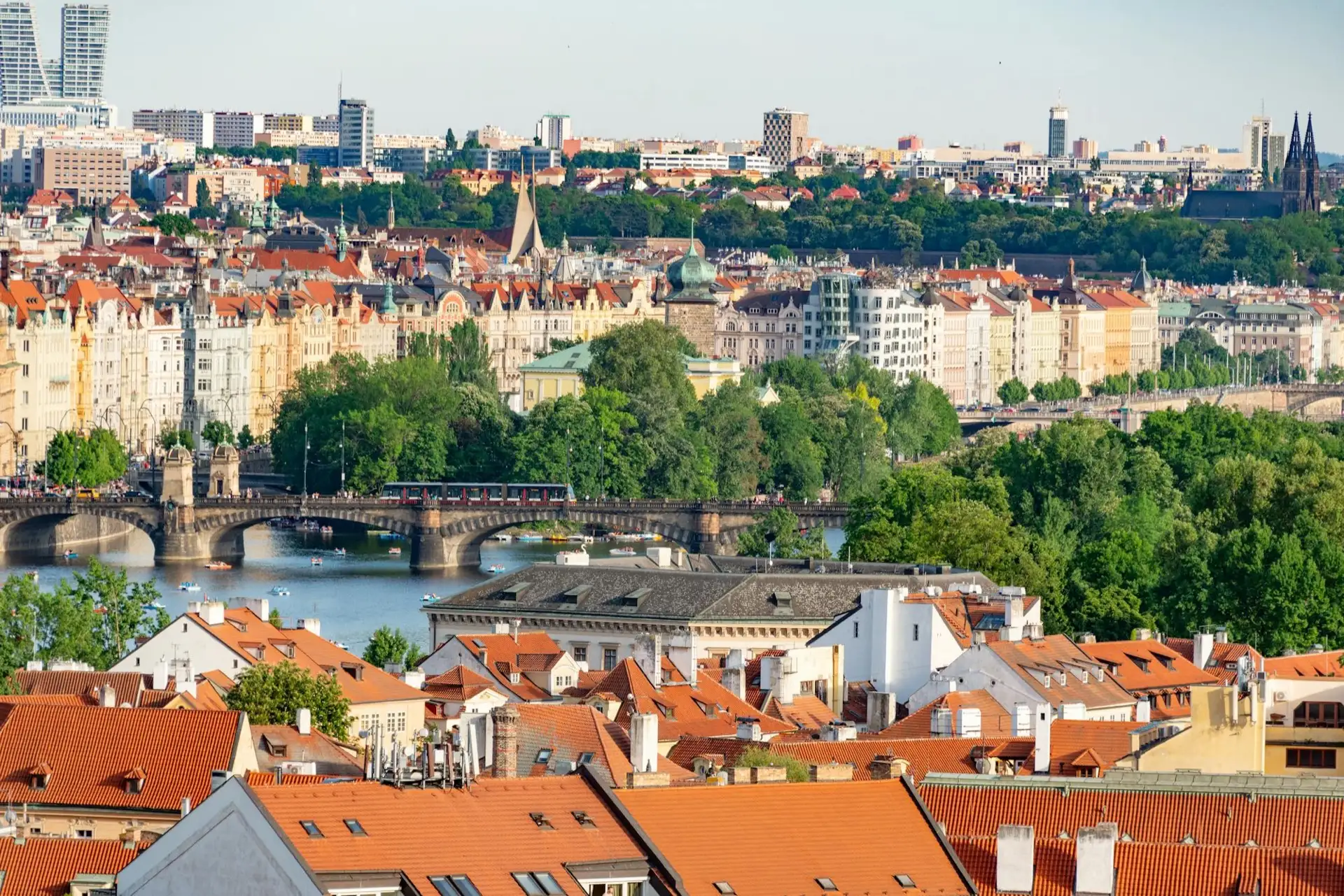 Prague's spires, red rooftops and the bridges over the Vltava seen from above