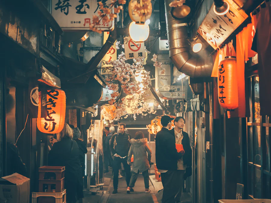 A lantern-lit izakaya alley crowded with diners at night