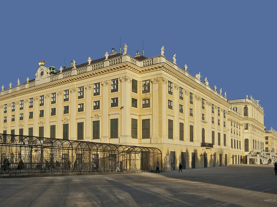 The golden façade of Schönbrunn Palace in Vienna glowing in low evening light